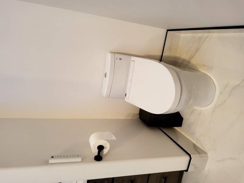 Contemporary bathroom remodeling with frameless glass shower enclosure